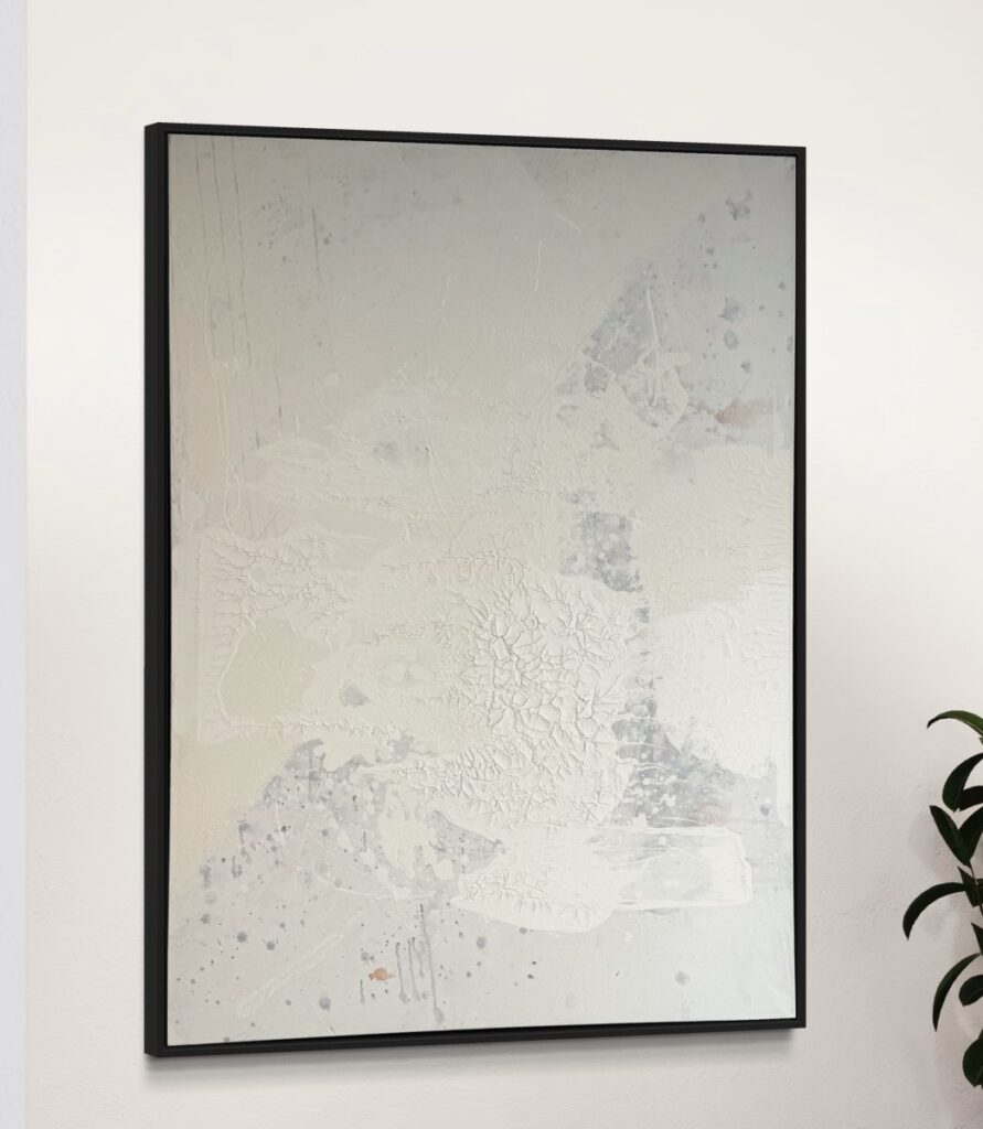 An abstract painting titled "Pure Layers" by Gina Keatley, showcasing a textured surface of muted whites, soft creams, and subtle gray undertones. The artwork features delicate craquelure with fine cracks and organic patterns, creating a tactile, layered effect. Speckled drips and soft splashes enhance the composition with a sense of spontaneity, while a subtle touch of mandarin orange peeks through the muted tones. Framed in black, the piece exudes an understated elegance, blending simplicity with depth and natural imperfection.